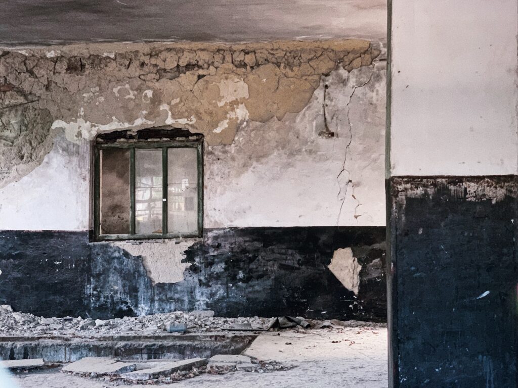 Shabby damaged wall in ruined building